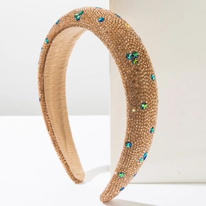 Detail of padded headband with emerald green stars and dense crystal rhinestones