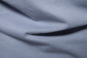 Macro shot of breathable gray-blue pique knit fabric texture on men's polo shirt