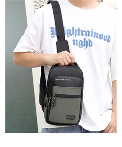Detail of men's nylon chest bag with green and black contrast and adjustable strap