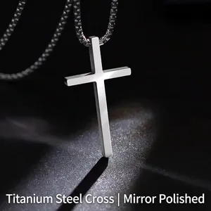Macro detail of polished titanium steel cross pendant with a shiny mirror finish