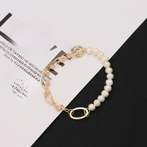 Asymmetric natural pearl bracelet with pink crystals and gold OT clasp on card