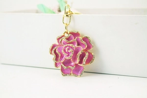 Detailed macro view of pink enamel rose keychain with sparkling crystal embellishments