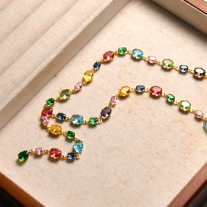 Close-up of colorful gemstone necklace with oval crystals in a premium jewelry box