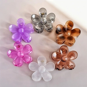 Set of six colorful flower-shaped hair claws in various translucent and matte finishes