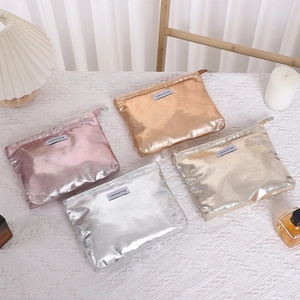 Detailed top view of four metallic PU leather makeup bags in pink, gold, and silver