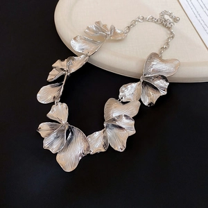 Detail of silver ginkgo leaf necklace showing textured metal finish and lobster clasp