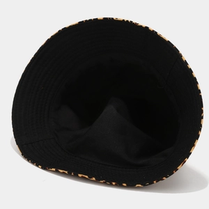 Reversible leopard print bucket hat with yellow animal pattern and black inner lining