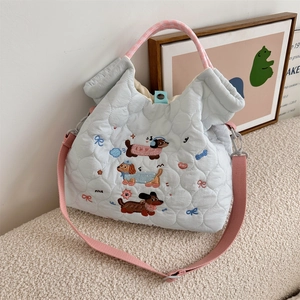 Detail of dachshund embroidery on light blue quilted tote with pink checkered handles