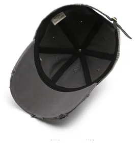 Detailed interior of vintage grey washed baseball cap with distressed hole craft and strap