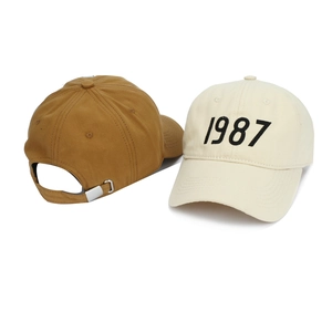 Detail of adjustable metal buckle and 1987 embroidery on cotton baseball caps