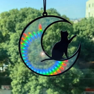 Detailed view of rainbow light effects on a black silhouette cat and moon suncatcher