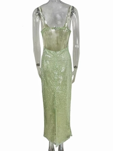 Detail of mint green sequin dress showing backless design and rear slit hemline
