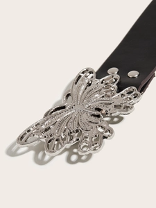 Close-up of a stylish butterfly metal buckle on a black punk-style leather belt
