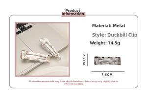 Detail view of silver wavy metal hair clip with measurements 7.5cm by 2.2cm and 14.5g weight