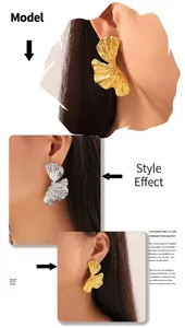 Detailed close-up of ginkgo leaf stud earrings with textured gold and silver finishes