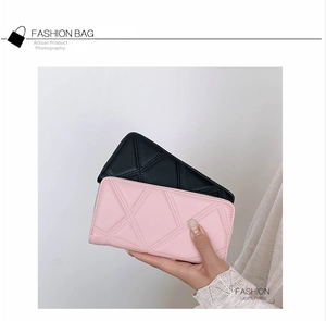 Detail of pink and black long zip-around PU leather wallets with geometric quilted patterns