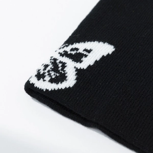Detailed close-up showing white butterfly jacquard pattern on black knitted fabric