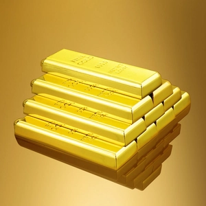 Creative gold bar keychains stacked on reflective surface with fine gold engraving