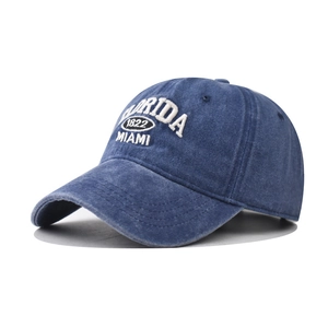 Close-up of white 3D Florida Miami 1822 embroidery on washed navy cotton baseball cap