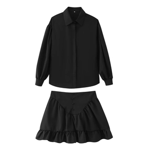 Flat lay of black long sleeve button shirt and ruffled mini skirt set on white background