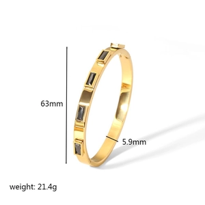 Macro detail of gold stainless steel bangle with grey rectangle stones and 63mm diameter