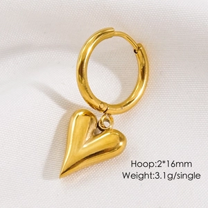 Detailed macro view of 16mm golden heart hoop earring weighing 3.1g on white fabric
