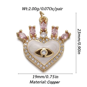 Detail of gold-plated copper heart crown evil eye pendant with pink zircon stones