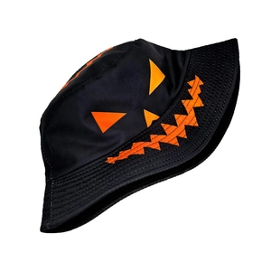 Close-up of orange Jack-o'-lantern pumpkin print on black Halloween bucket hat