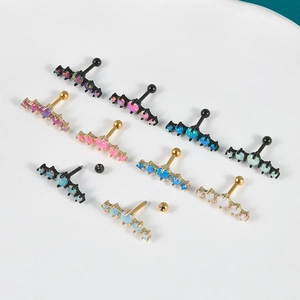 Surgical steel curved tragus piercing with five synthetic opals in gold and black finish