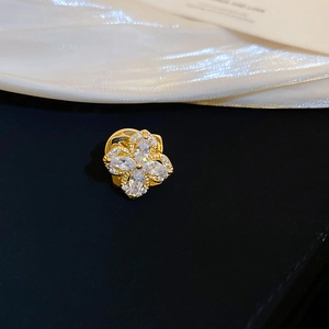 Macro detail of gold-plated floral brooch featuring marquise zirconia and micro-pave setting