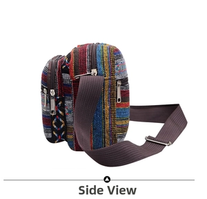 Side view of ethnic canvas shoulder bag with colorful stripes and multiple zipper pockets