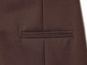 Detailed close-up of premium dark brown twill fabric with professional double welt pocket