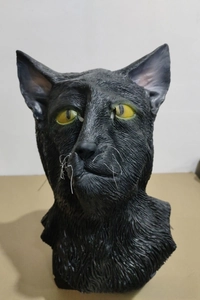 Macro shot of realistic black cat mask with lifelike fur texture and yellow eyes