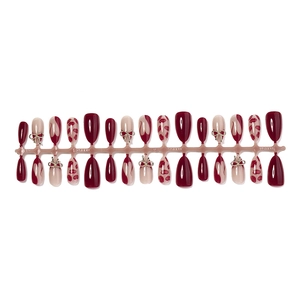 Long ballet press-on nails with burgundy heart patterns and 3D metal bow accents