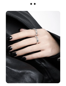 Detail of S925 sterling silver couple rings with textured bands and small inlaid diamonds
