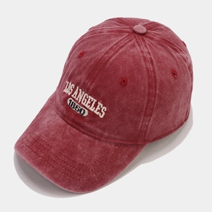 Close-up of vintage burgundy washed cotton baseball cap with white Los Angeles embroidery