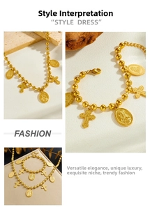 Detailed close-up of vintage gold oval saint medal and cross charms on beaded chain jewelry set