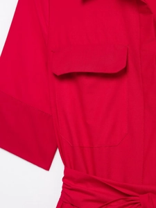 Detail of red shirt dress featuring a chest flap pocket and waist tie belt