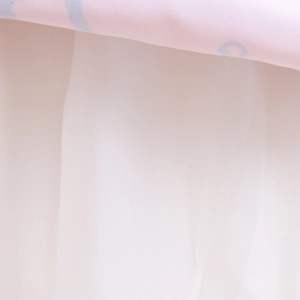 Macro shot of fine white mesh tulle lining on a pink Halloween girls' pumpkin dress