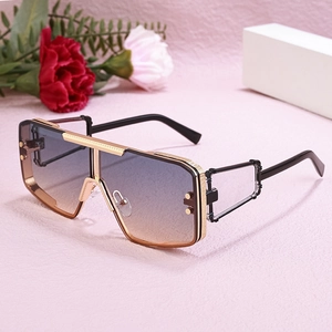 Detail of futuristic punk sunglasses with gold metal frame and gradient blue-brown lens