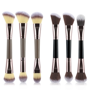 Detail of dual-ended makeup brushes with rose gold ferrules and soft gradient bristles