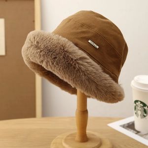 Winter plush bucket hat in brown with warm beige faux fur trim and metal label