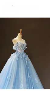 Detail of light blue off-shoulder gown with exquisite white lace embroidery and 3D floral appliques