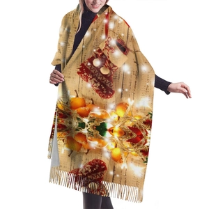Christmas cashmere-like scarf with festive orange and sock prints and tassels for women