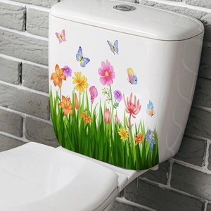 Close-up of floral toilet sticker with colorful flowers and butterflies on grey wall