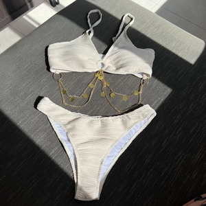 Chic cream white ruched bikini set with gold chain links and metallic ring accents