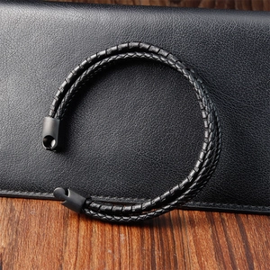 Detail of double-layer black braided leather cord and matte black metal clasp for men