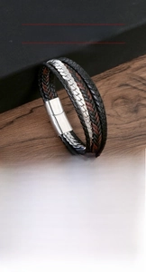 Macro detail of multi-layer leather braid and silver stainless steel magnetic clasp