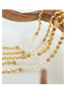 Detail of chic freshwater pearls and gold beads on a branch, high-end French style jewelry