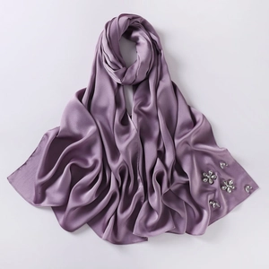 Detailed close-up of lavender chiffon hijab featuring exquisite rhinestone flower patterns